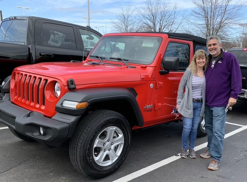 Mike and Susan of RVBlogger standing next to their 2020 Jeep Wrangler