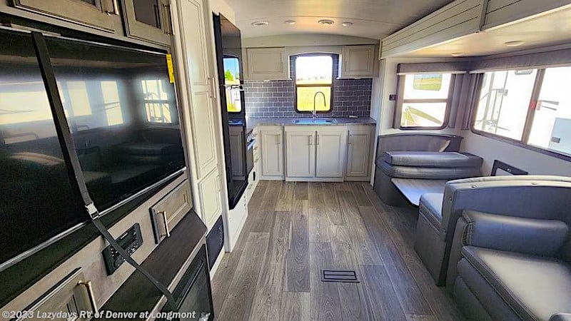 2024 Keystone Cougar 30RKD interior showing the rear kitchen, dinetter and TV location