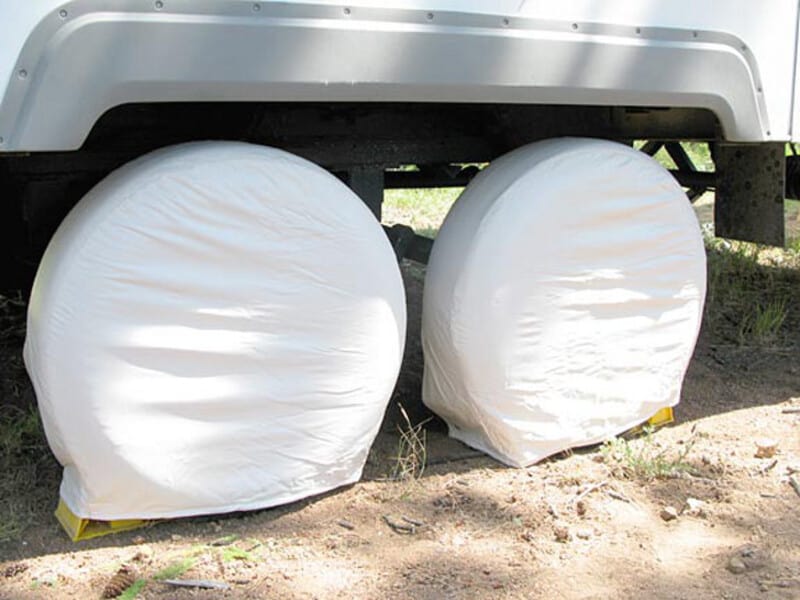 Dual axle trailer with tire covers on - truck tires on travel trailers