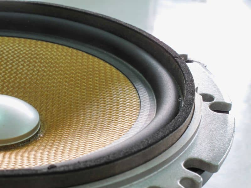 close up view of a audio speaker with yellow center