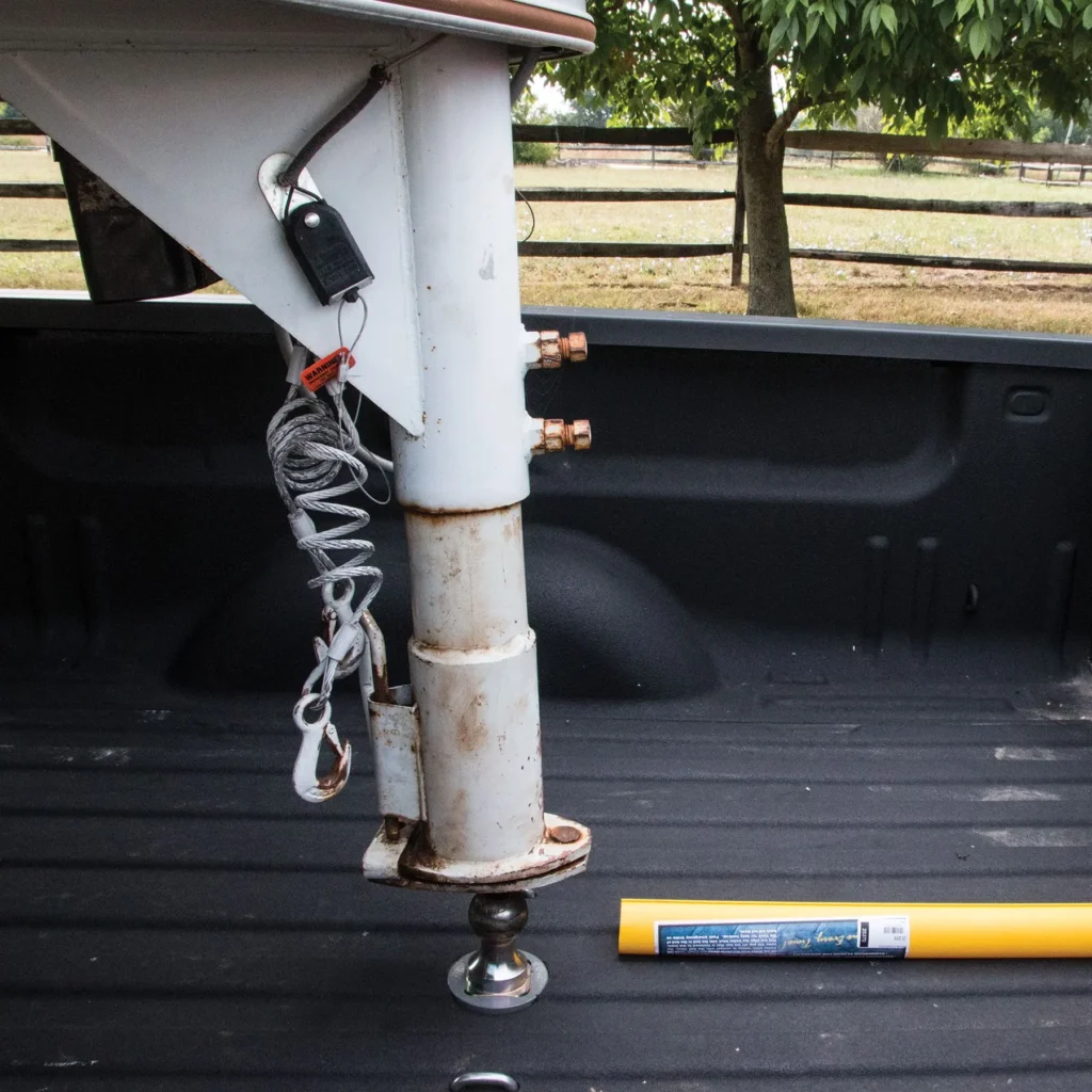 Close up of a gooseneck hitch sitting above the ball in the bed of a truck - bumper pull to gooseneck conversion
