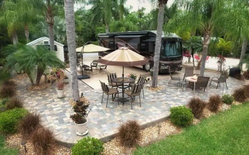 Large Class A motorhome parked on a fancy RV resort site with palm trees