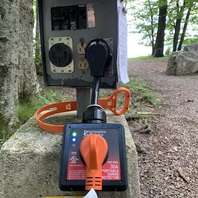 RV surge protector plugged in at a campground