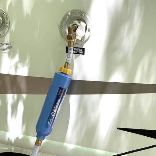 RVBlogger water filter on the side of their Class C RV